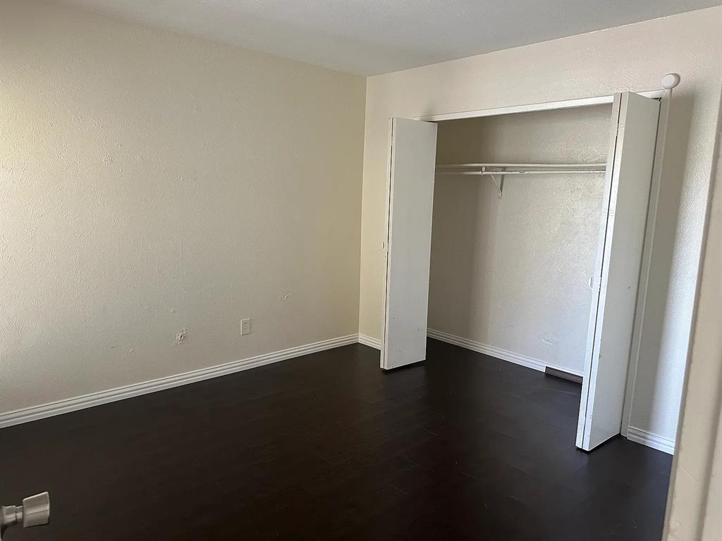 2414 Limestone Drive Arlington, TX 76014 - Photo 13 of 18 an empty room with wooden floor and closet