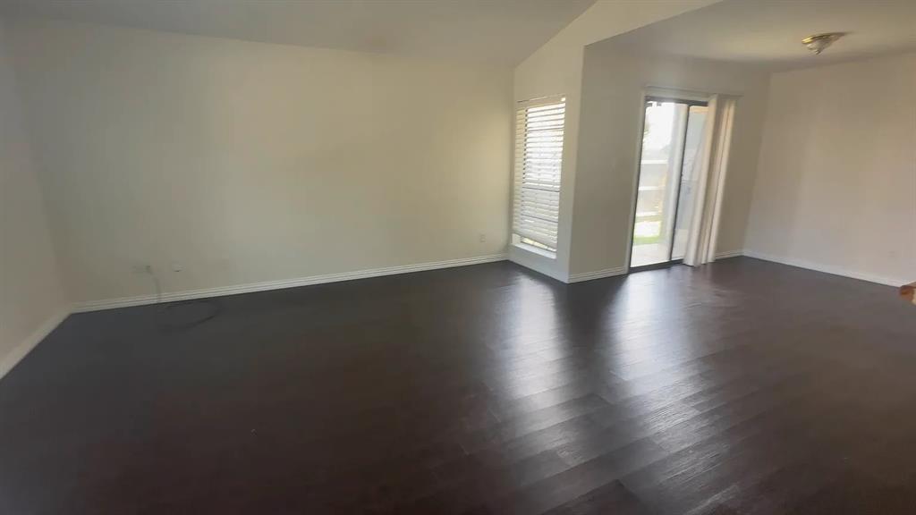 2414 Limestone Drive Arlington, TX 76014 - Photo 15 of 18 an empty room with wooden floor and windows