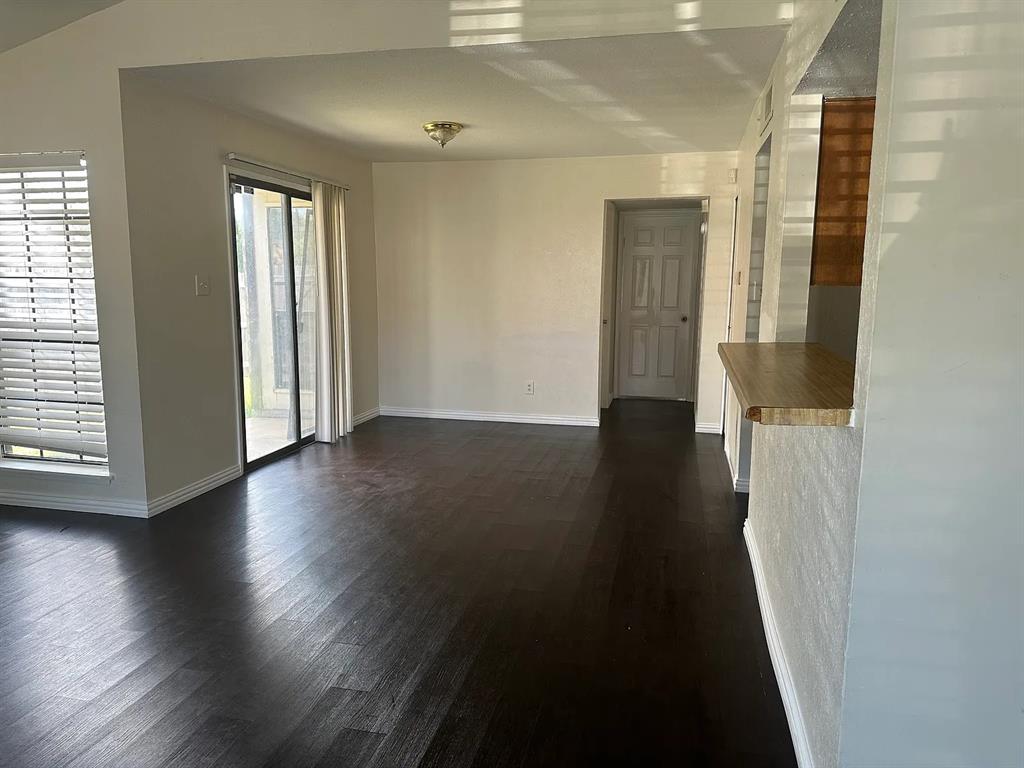 2414 Limestone Drive Arlington, TX 76014 - Photo 4 of 18 an empty room with wooden floor and windows