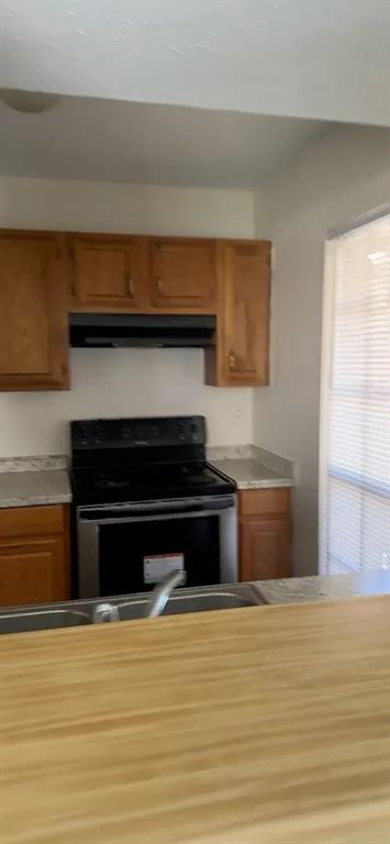 2414 Limestone Drive Arlington, TX 76014 - Photo 5 of 18 a kitchen view with wooden floor and a fireplace