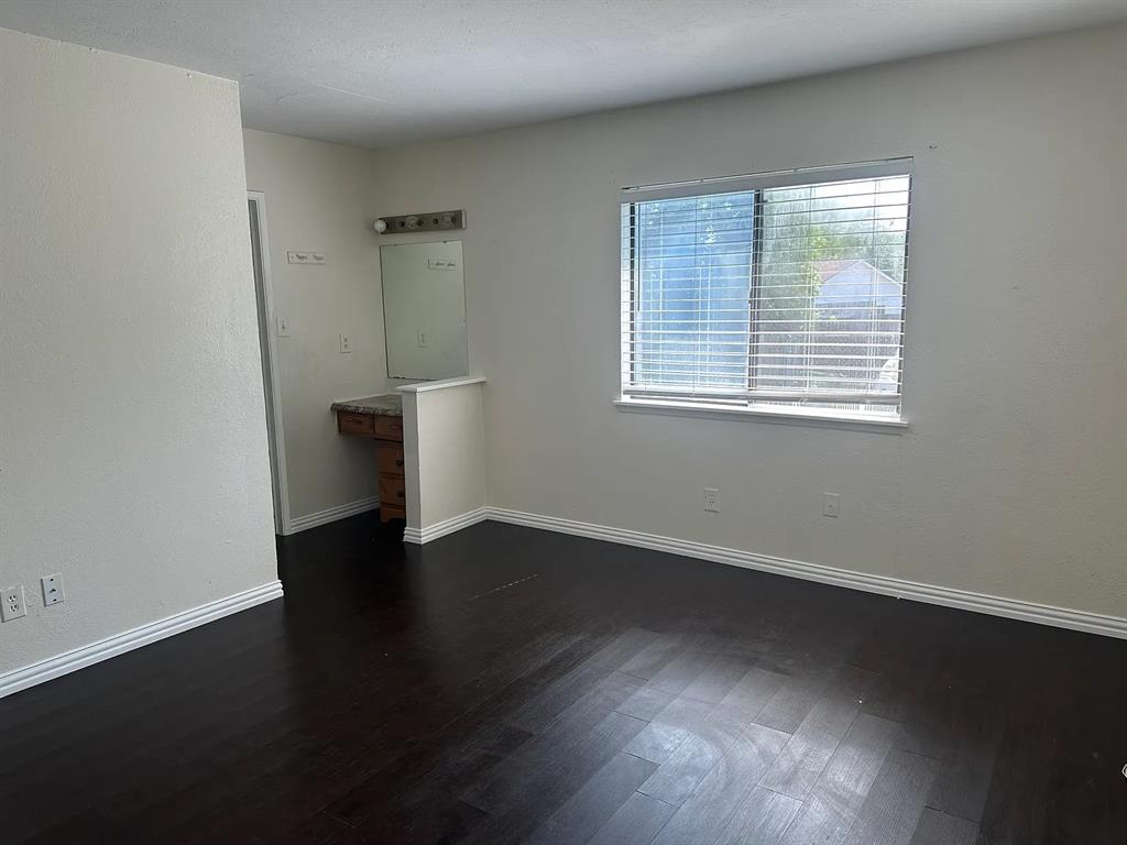 2414 Limestone Drive Arlington, TX 76014 - Photo 7 of 18 an empty room with wooden floor and windows