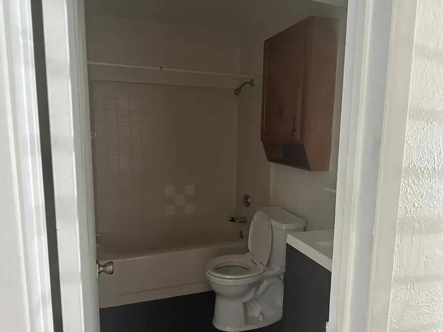 a bathroom with a toilet and a shower