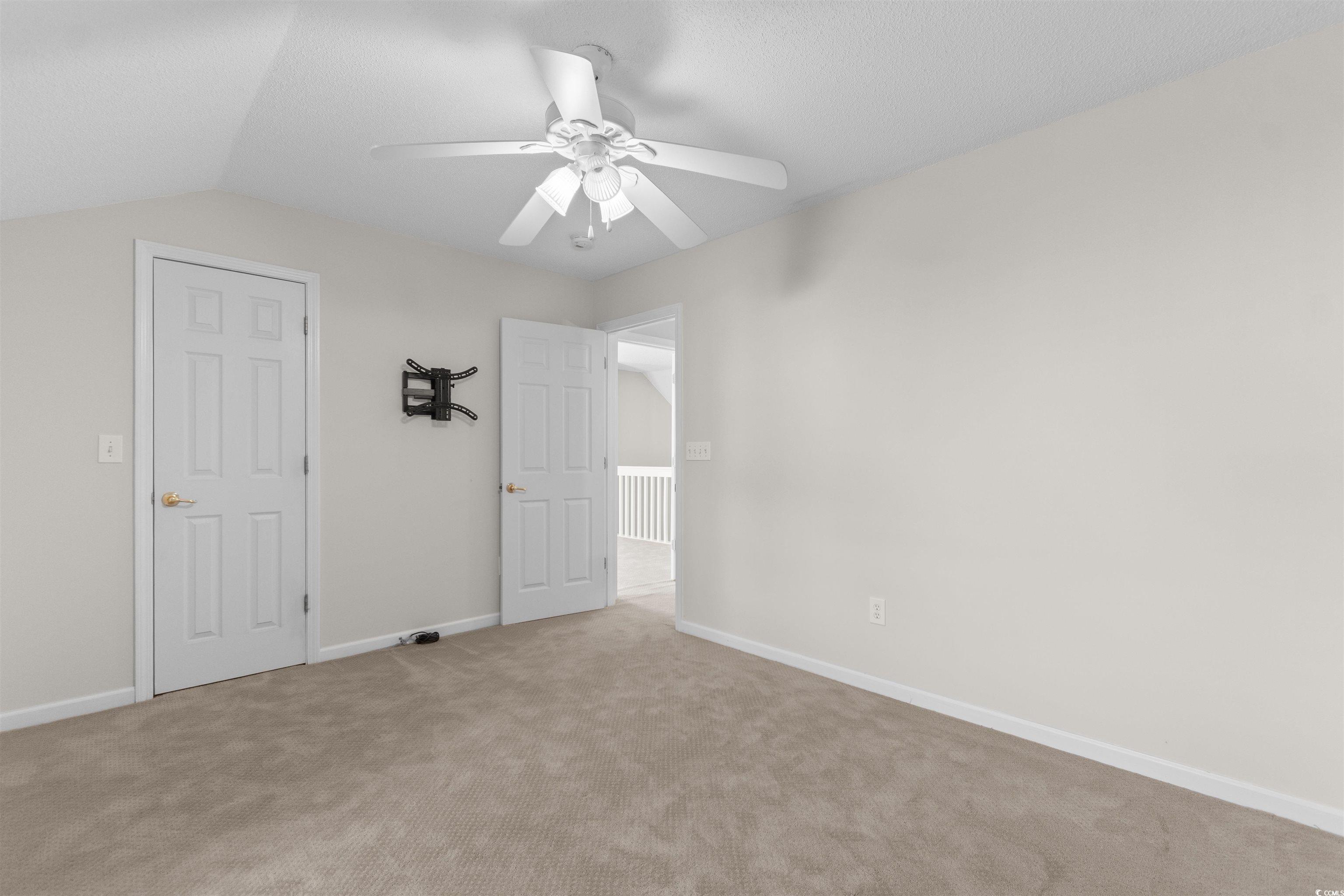 153 Wimbledon Way, Unit 153 Murrells Inlet, SC 29576 - Photo 24 of 32 Unfurnished bedroom with carpet floors, a ceiling fan, and lofted ceiling