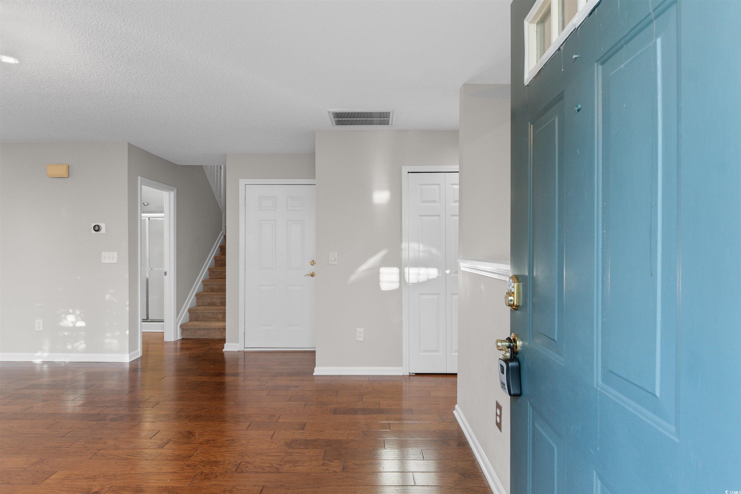 153 Wimbledon Way, Unit 153 Murrells Inlet, SC 29576 - Photo 4 of 32 Entryway with stairs, dark wood-style flooring, and a textured ceiling