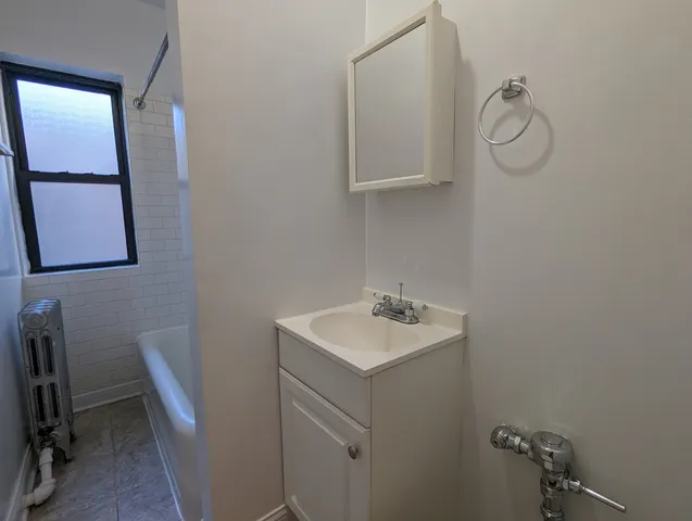 a bathroom with a sink a light fixture and a toilet