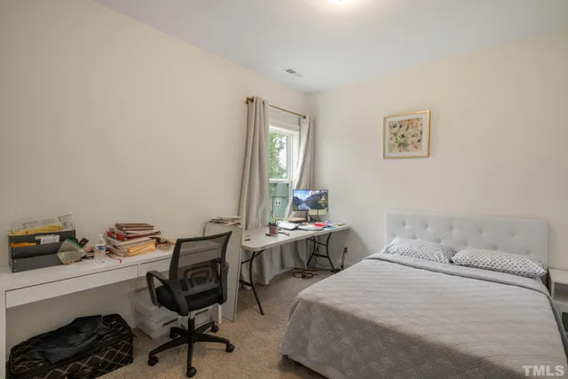 a bedroom with a bed and a desk