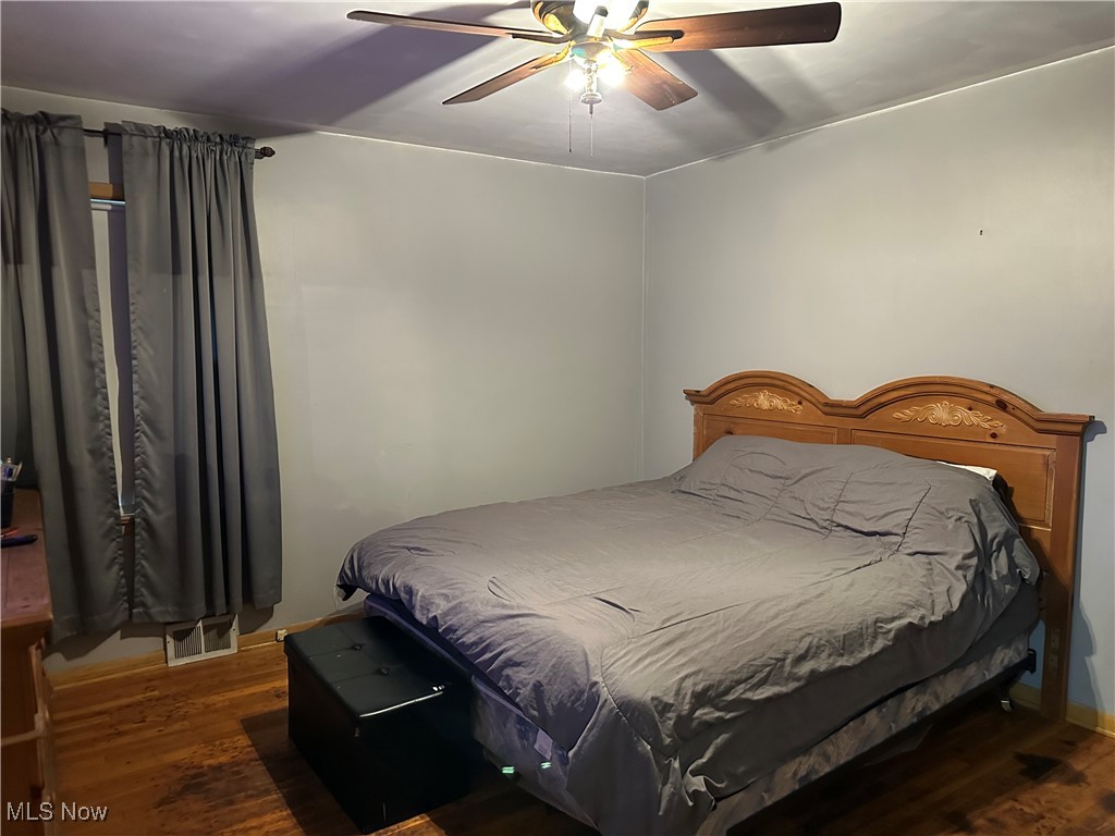 12303 Orme Road Garfield Heights, OH 44125 - Photo 11 of 22 Bedroom featuring visible vents, ceiling fan, and wood finished floors