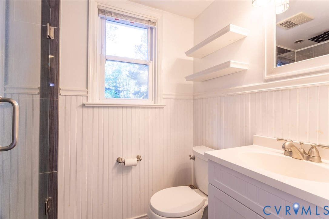 4157 New Market Road Henrico, VA 23231 - Photo 17 of 43 Full bath with vanity, a wainscoted wall, and a st