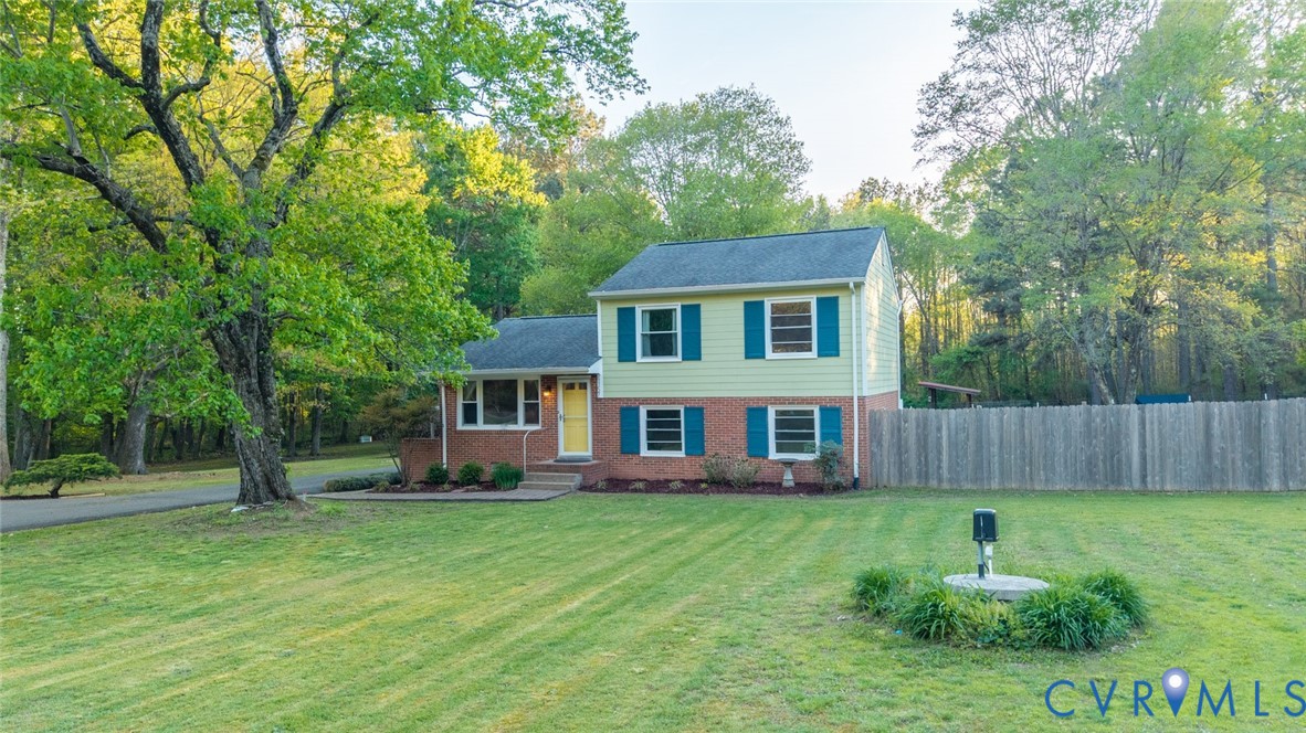 4157 New Market Road Henrico, VA 23231 - Photo 2 of 43 Tri-level home with brick siding and view of woode