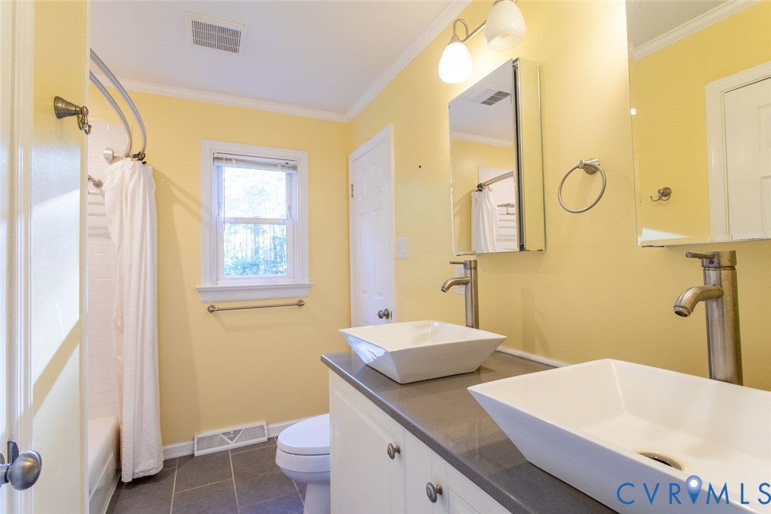 4157 New Market Road Henrico, VA 23231 - Photo 27 of 43 Full bathroom with double vanity, ornamental moldi