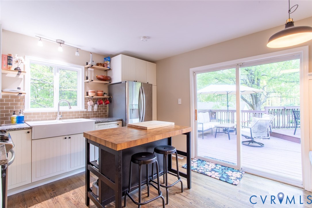 4157 New Market Road Henrico, VA 23231 - Photo 10 of 43 Kitchen with backsplash, white cabinets, stainless
