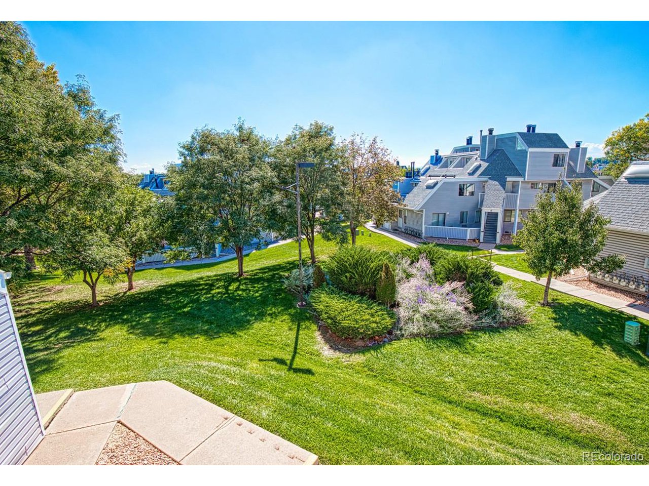 8701 Huron Street, Unit 209 Thornton, CO 80260 - Photo 15 of 25 a view of a garden with a building in the background