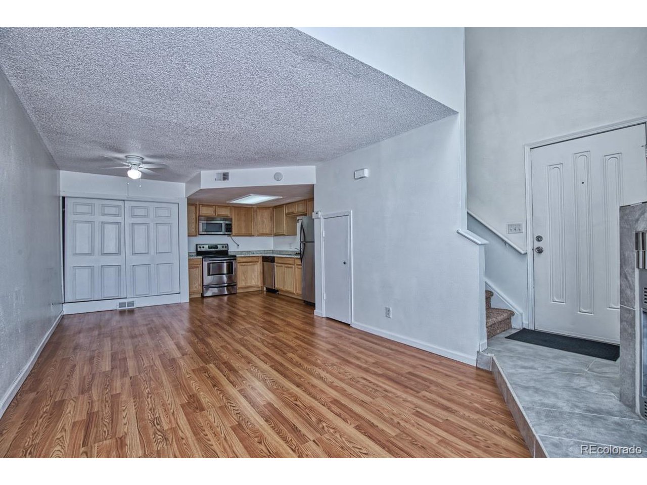 8701 Huron Street, Unit 209 Thornton, CO 80260 - Photo 3 of 25 a view of empty room with wooden floor