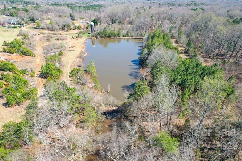 553 Loray Farm Road Dallas, NC 28034 - Photo 15 of 48 a view of a lake with large trees