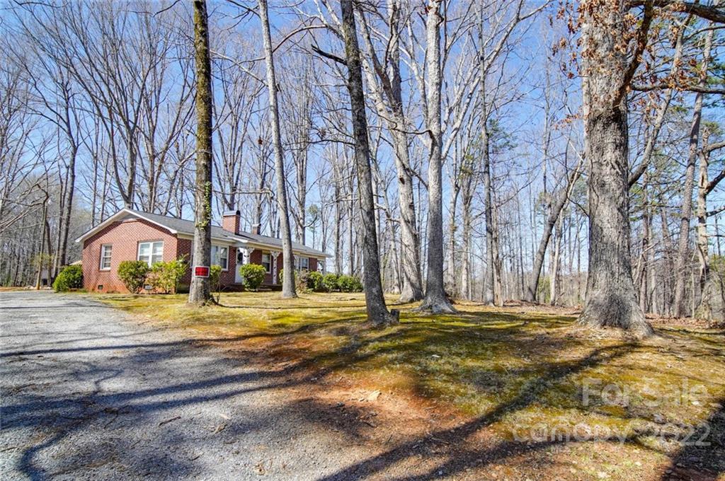 553 Loray Farm Road Dallas, NC 28034 - Photo 2 of 48 a view of dirt yard with large trees