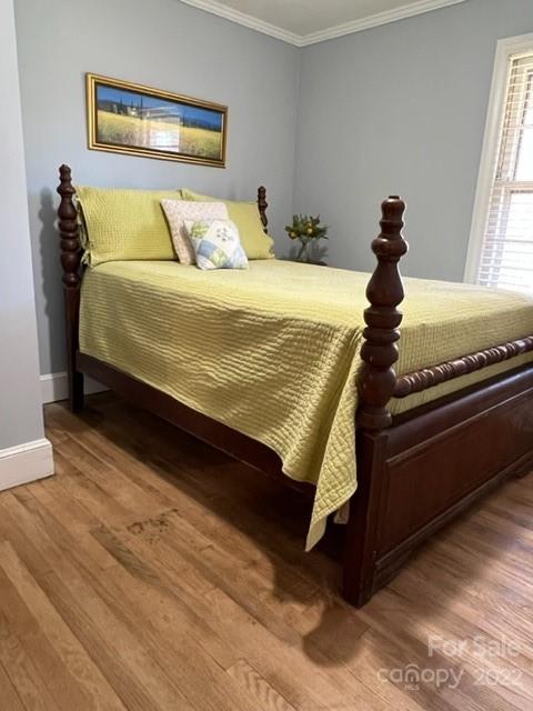 553 Loray Farm Road Dallas, NC 28034 - Photo 22 of 48 a bed sitting in a bedroom next to a window