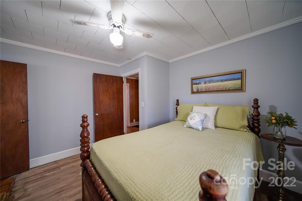 553 Loray Farm Road Dallas, NC 28034 - Photo 23 of 48 a bed room with a bed and a chandelier