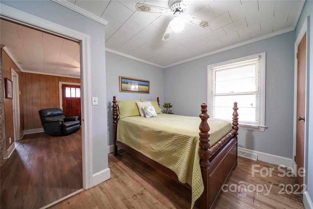 553 Loray Farm Road Dallas, NC 28034 - Photo 24 of 48 a bedroom with a bed and a chandelier