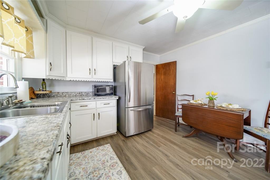 553 Loray Farm Road Dallas, NC 28034 - Photo 26 of 48 a kitchen with a refrigerator and a stove top oven