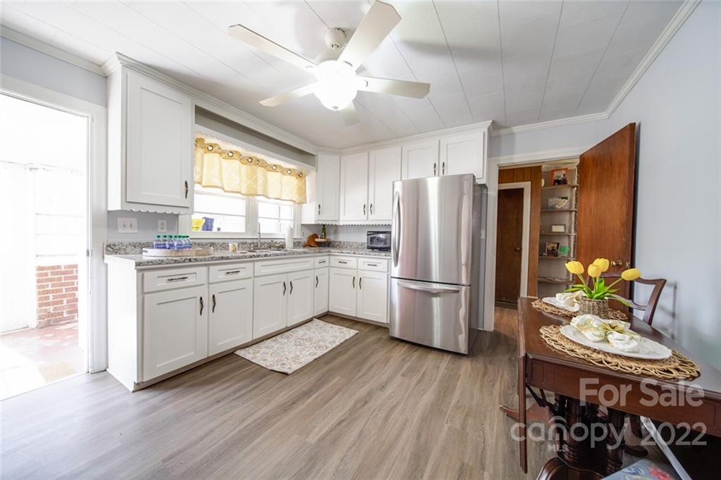553 Loray Farm Road Dallas, NC 28034 - Photo 27 of 48 a kitchen with a refrigerator a stove a dining table and chairs