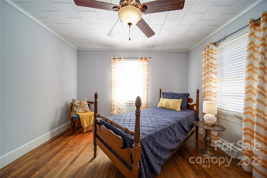 553 Loray Farm Road Dallas, NC 28034 - Photo 31 of 48 a bedroom with a bed and wooden floor