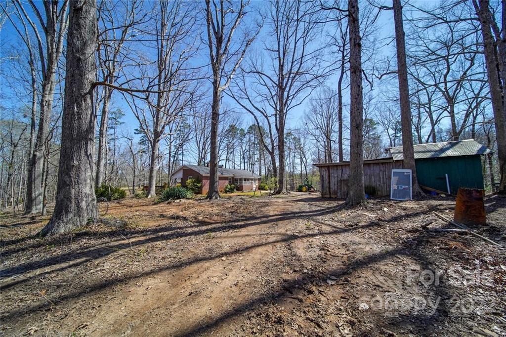 553 Loray Farm Road Dallas, NC 28034 - Photo 6 of 48 a view of a backyard with large trees