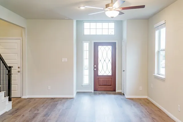 wooden floor in an empty room with a window