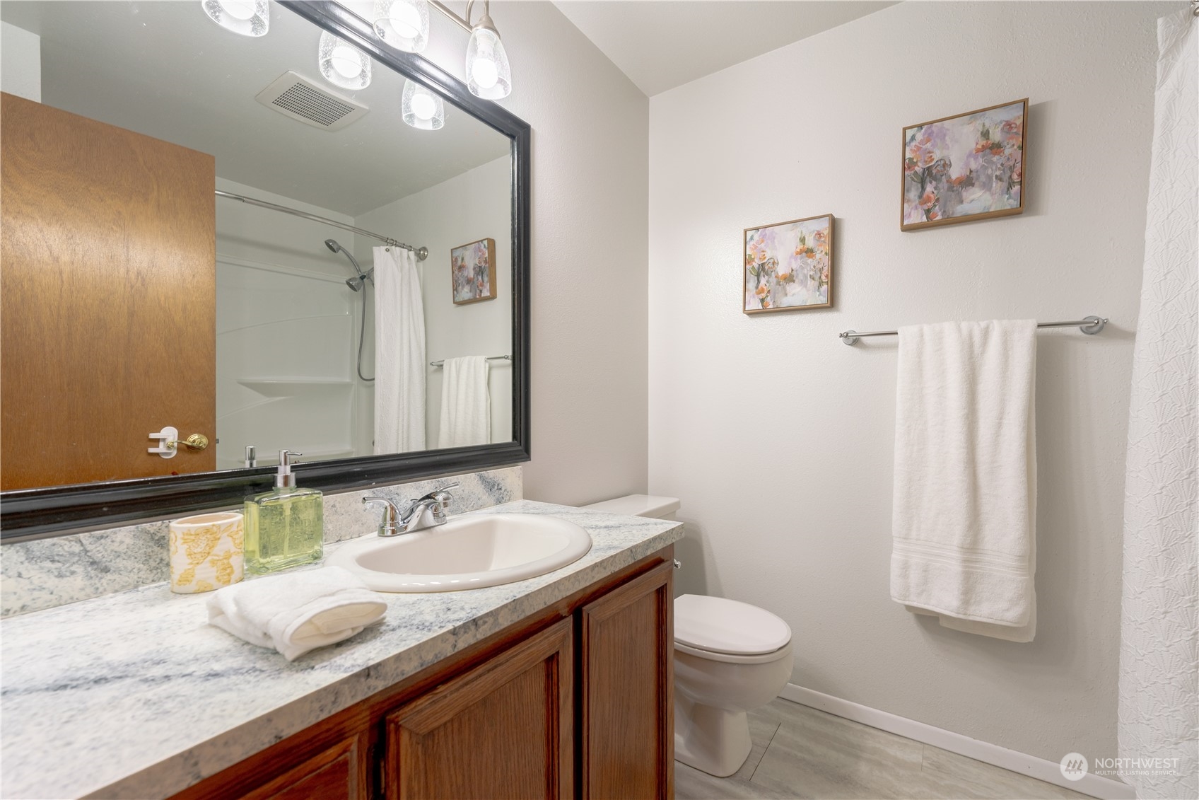 1213 228th Place Southwest Bothell, WA 98021 - Photo 23 of 40 a bathroom with a granite countertop sink toilet and a mirror