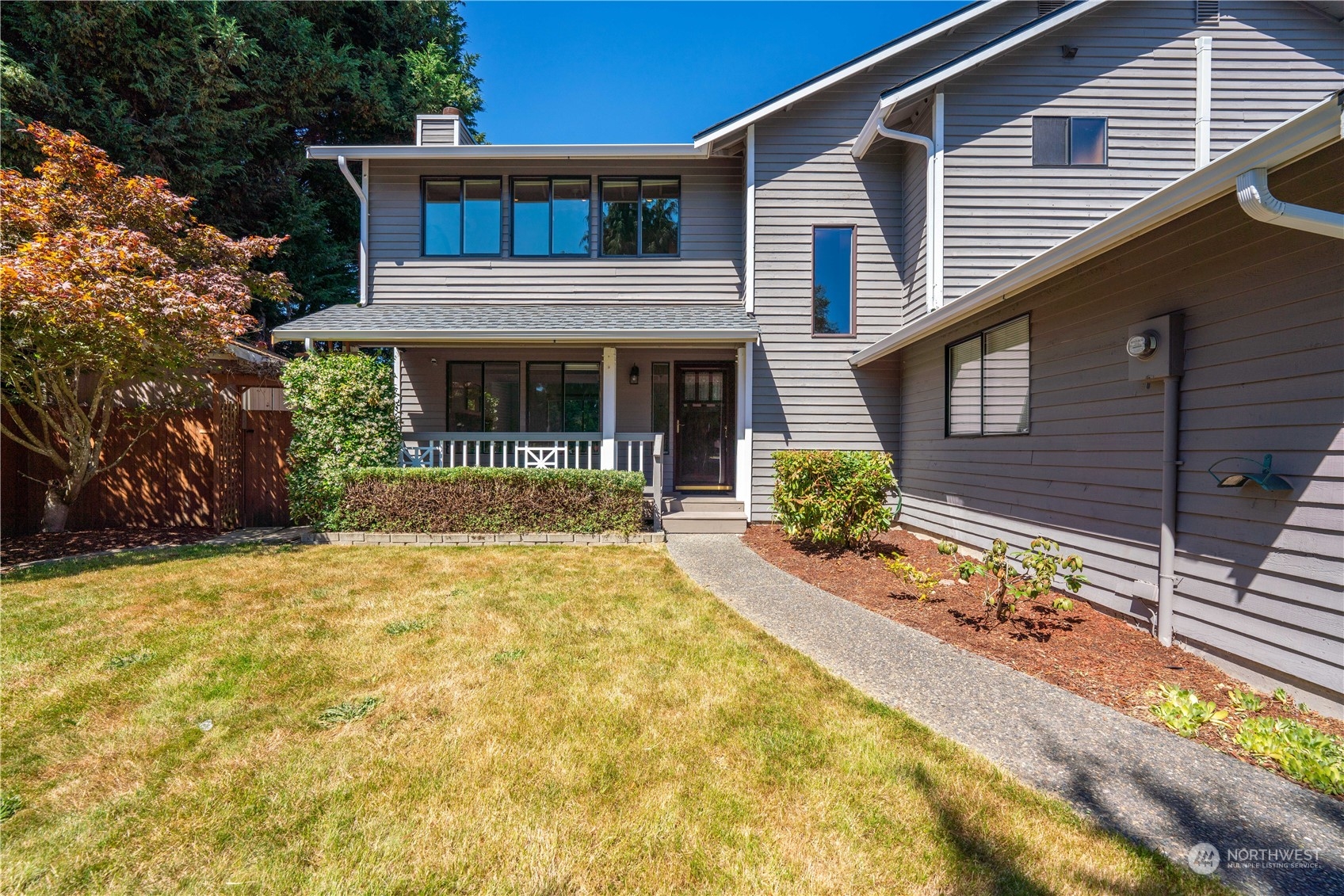 1213 228th Place Southwest Bothell, WA 98021 - Photo 39 of 40 a front view of a house with a yard