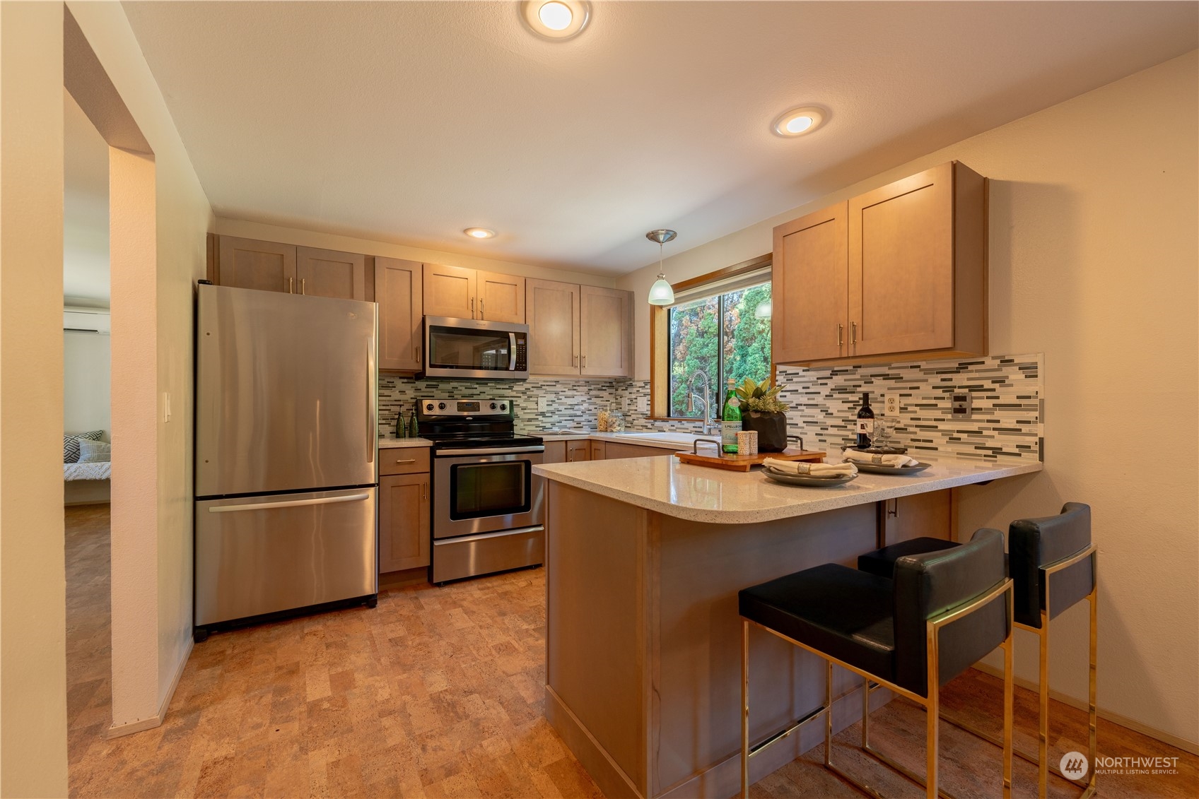 1213 228th Place Southwest Bothell, WA 98021 - Photo 9 of 40 a kitchen with kitchen island a sink stove and refrigerator