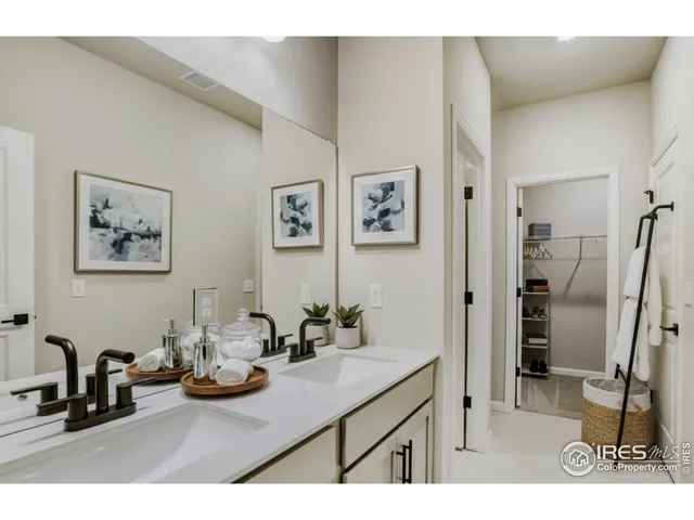 a bathroom with a double vanity sink and mirror