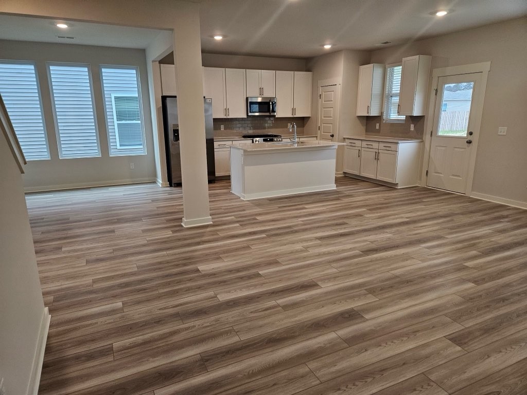 1311 Chambers Bay Drive, Unit LOT 802 Lebanon, TN 37087 - Photo 3 of 5 a large kitchen with stainless steel appliances granite countertop a stove and a refrigerator