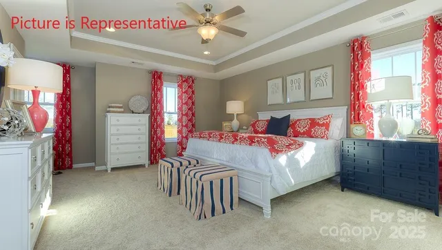 a bedroom with a bed next to a window