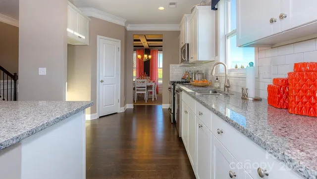 a kitchen with stainless steel appliances granite countertop wooden cabinets a sink and dishwasher