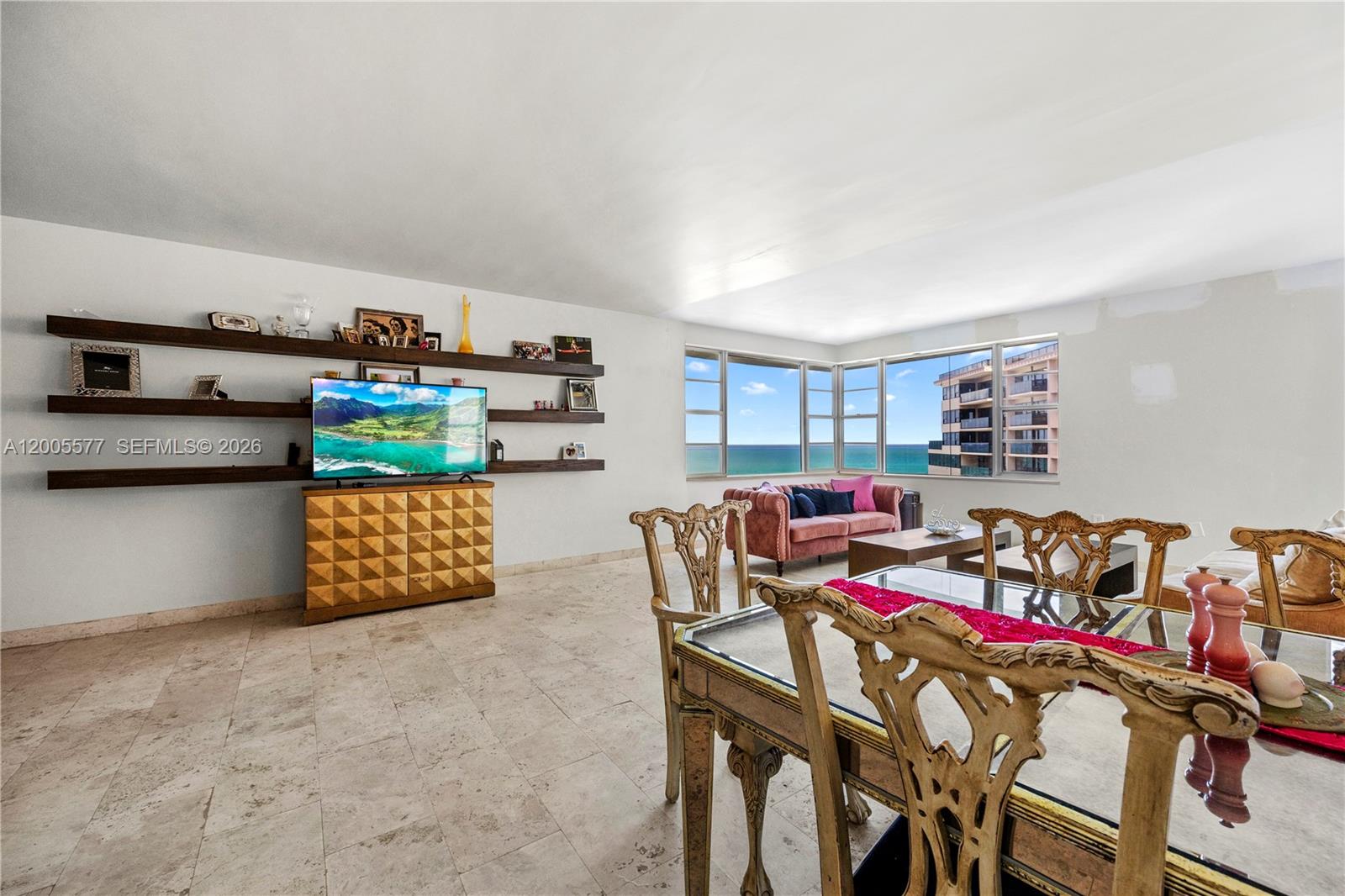 5255 Collins Avenue, Unit 11A Miami Beach, FL 33140 - Photo 1 of 15 a outdoor living space with furniture and a wooden floor