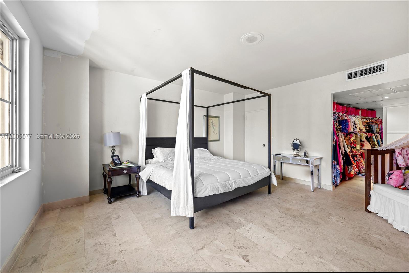 5255 Collins Avenue, Unit 11A Miami Beach, FL 33140 - Photo 4 of 15 a bedroom with a bed couch and a window