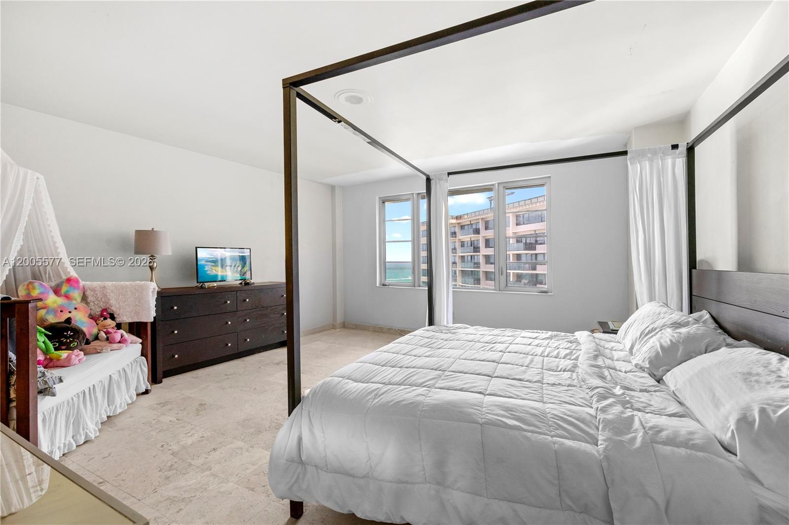 5255 Collins Avenue, Unit 11A Miami Beach, FL 33140 - Photo 5 of 15 a bedroom with a bed and a dresser