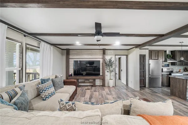 a living room with furniture and flat screen tv
