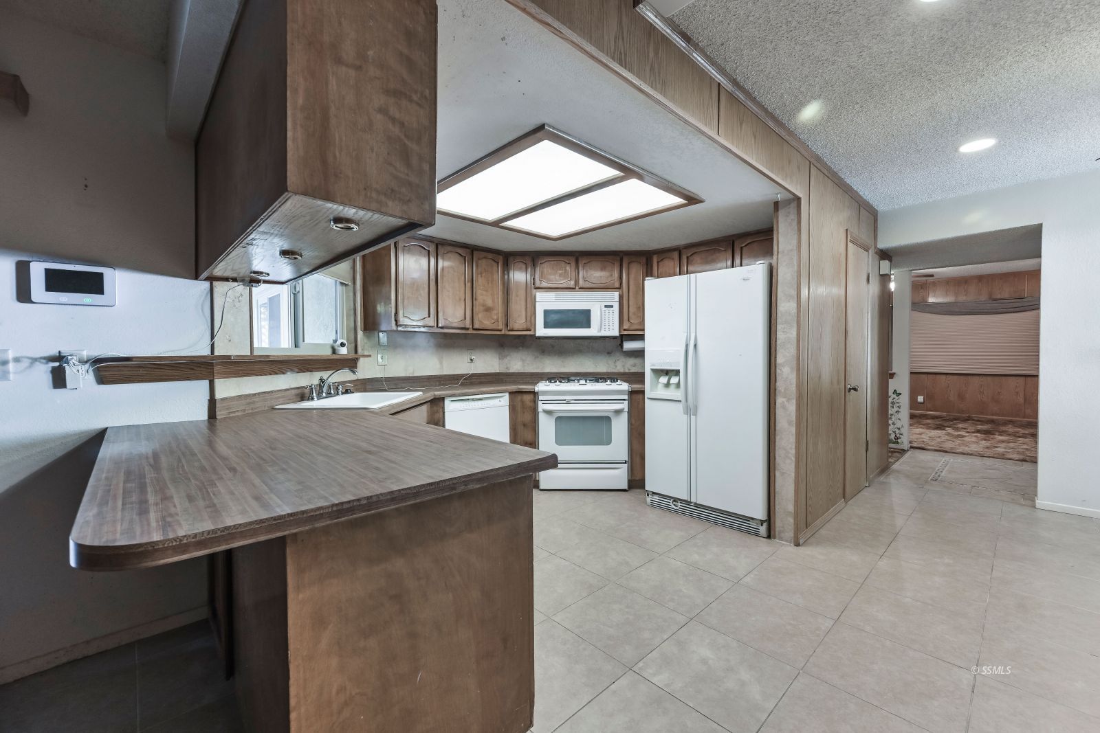 601 South Silver Ridge Street Ridgecrest, CA 93555 - Photo 5 of 34 a kitchen with stainless steel appliances granite countertop a sink a stove and a refrigerator