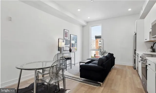 a living room with furniture and a dining table