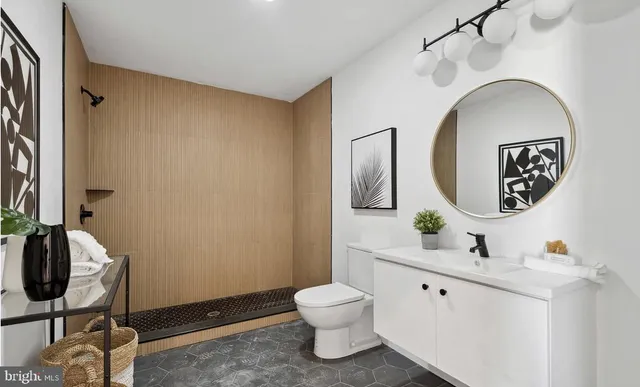 a bathroom with a toilet sink and mirror