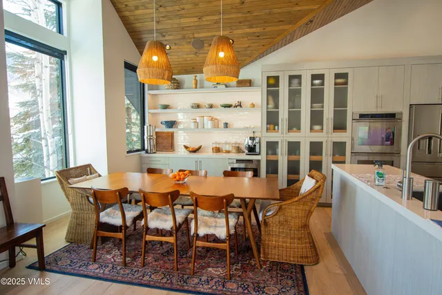 a dining room with a table and chairs