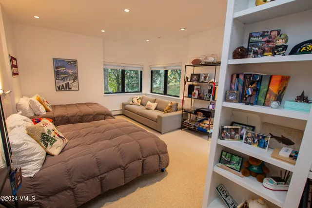 a living room with furniture and a book shelf