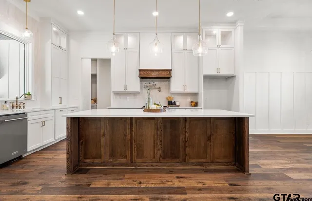 a kitchen with a sink appliances and cabinets