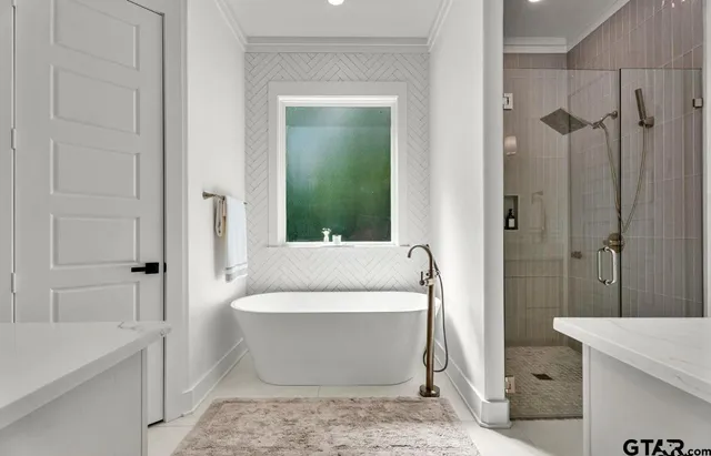 a bathroom with a bathtub and shower