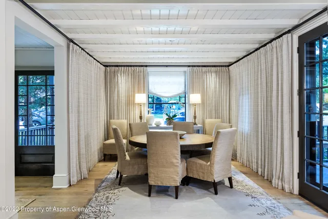 a dining room with furniture and window