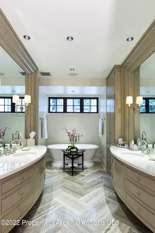 a bathroom with a sink mirror and a toilet