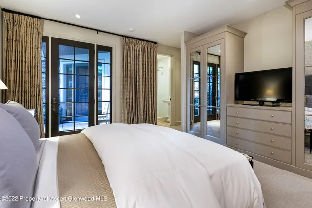 a bedroom with a bed and a flat screen tv in kitchen