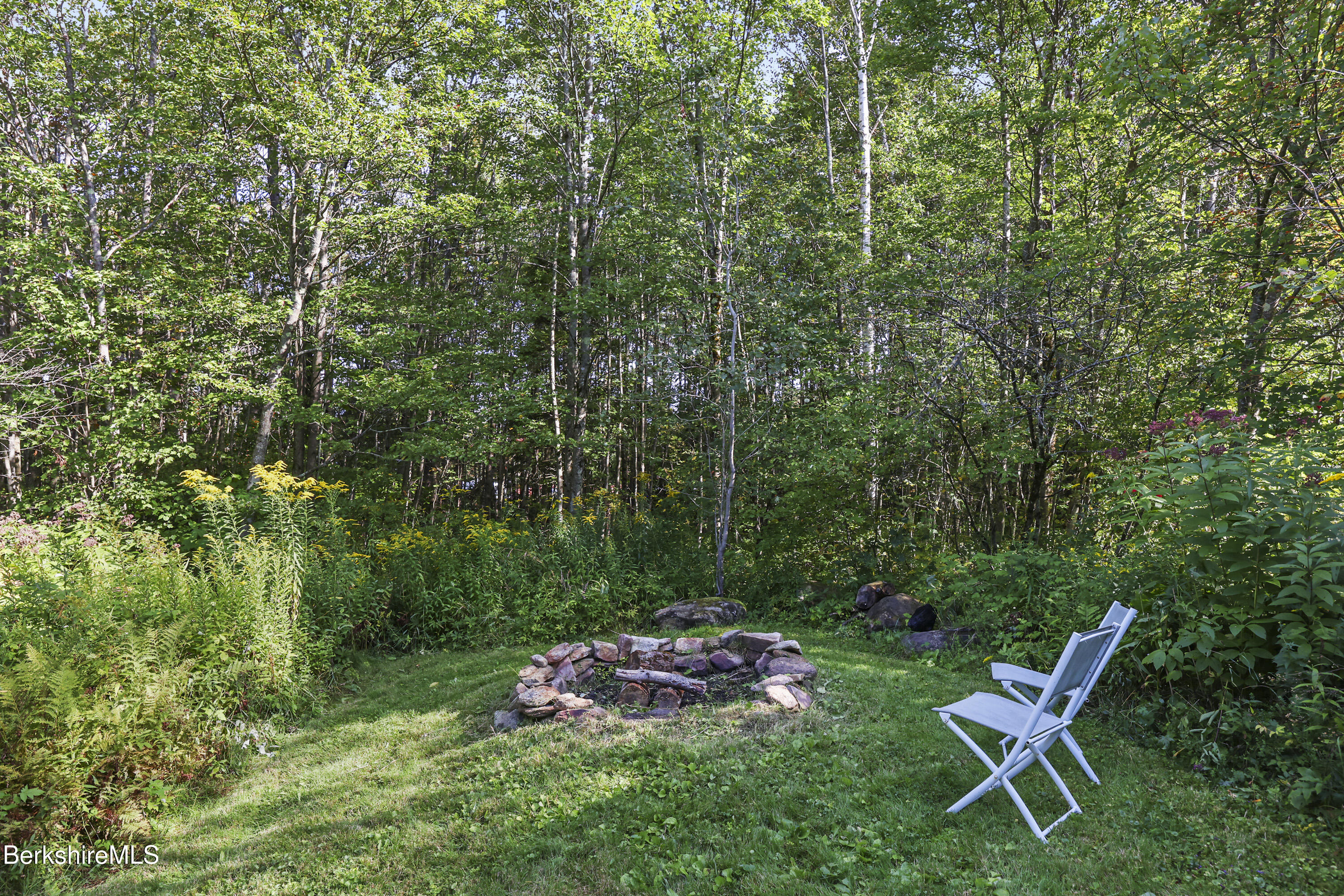 78 East Main Road Peru, MA 01235 - Photo 47 of 56 a backyard of a house with table and chairs