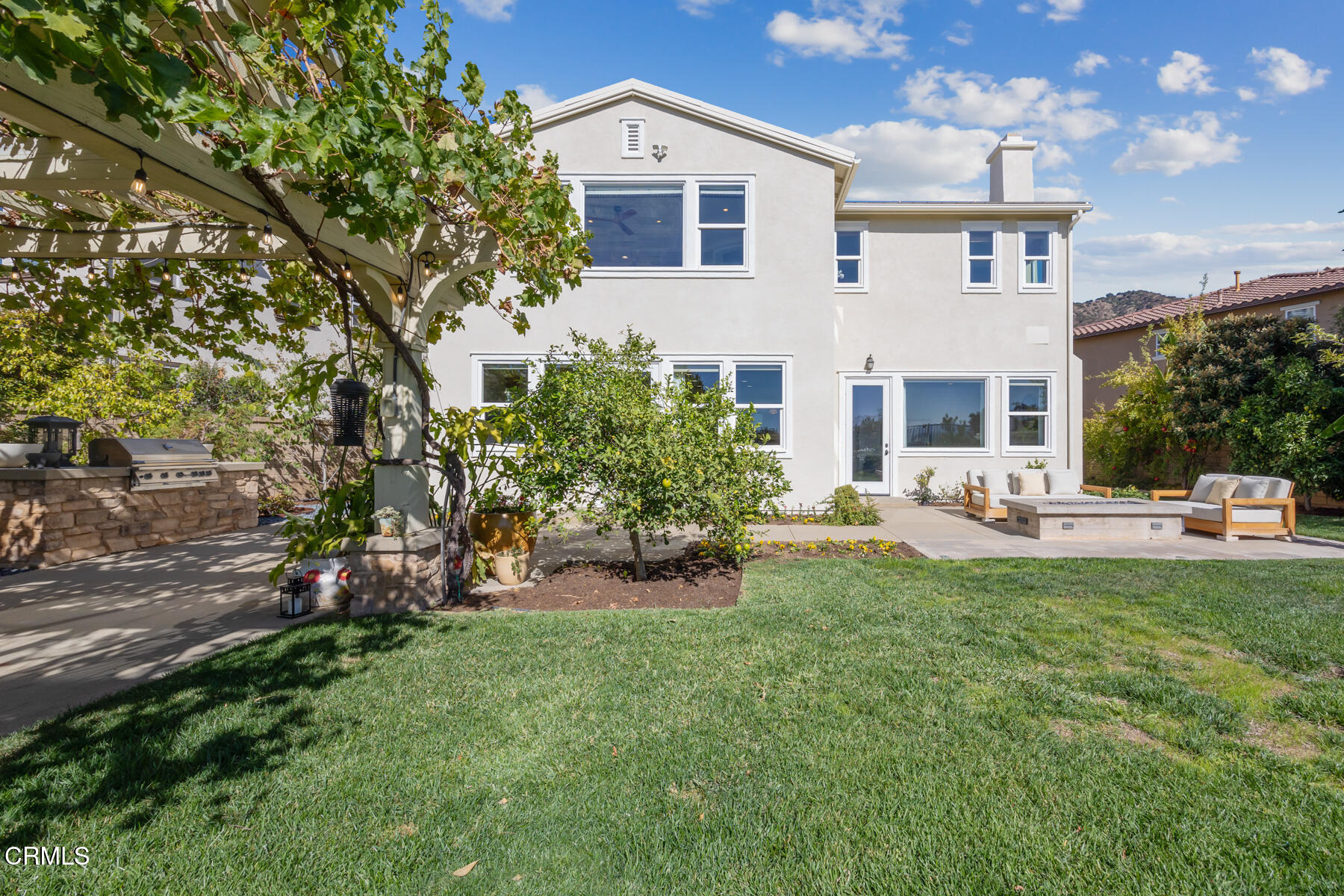 472 Desert Willow Road Azusa, CA 91702 - Photo 4 of 26 a view of a white house with a big yard and potted plants